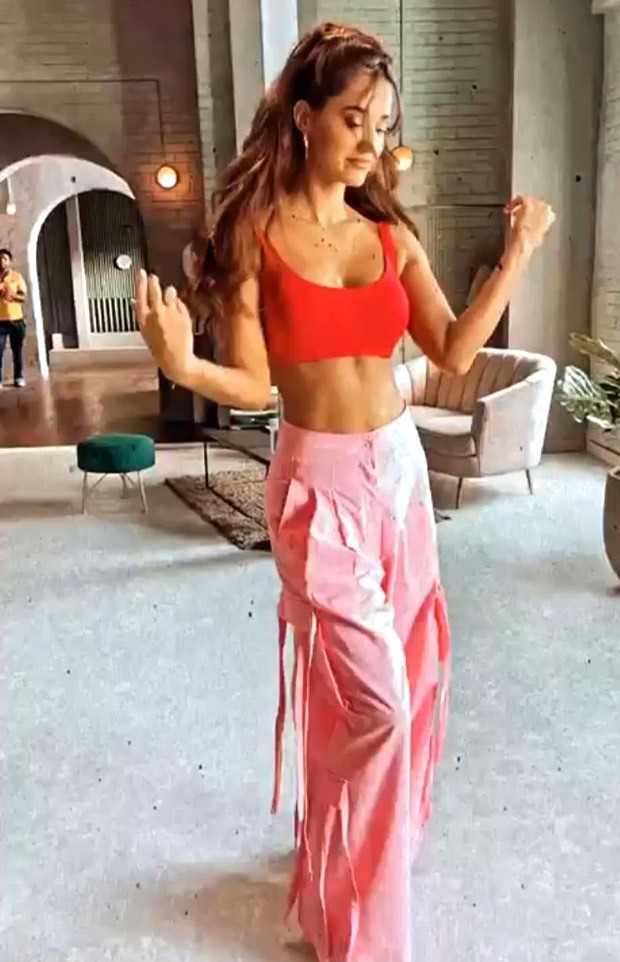 Disha Patani looks ravishing in a bubble gum pink utility pants and red crop top with a funky hair do