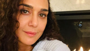 New mom Preity Zinta cuddles one of her twins in first picture of her newborn