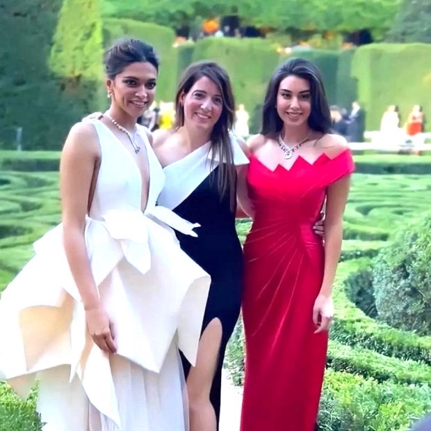 Deepika Padukone posed with Rami Malek and Yasmine Sabri, looking stunning in a white ruffled dress with a dangling neckline 