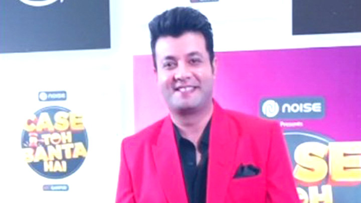 Varun Sharma poses for paps in a bright red suit