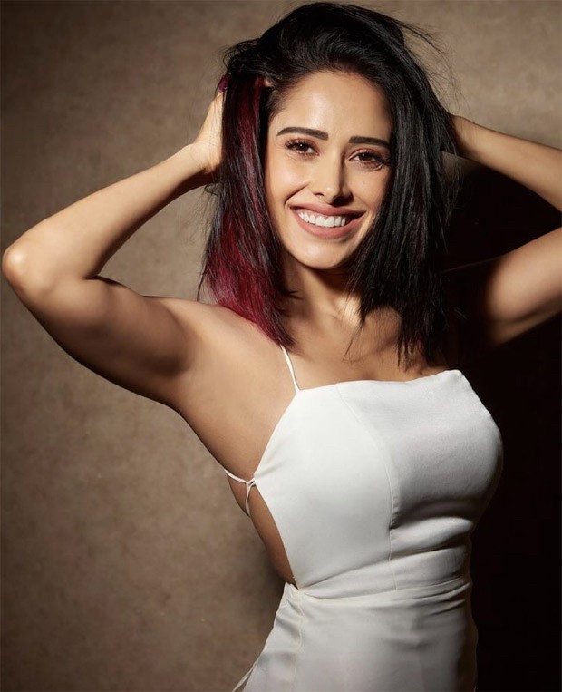 Nushrratt Bharuccha makes a statement in a chic white dress and red-coloured hair streaks