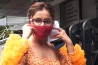 Rubina Dilaik poses for paps in an orange ruffled sleeve outfit