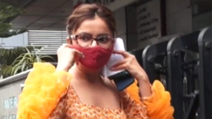Rubina Dilaik poses for paps in an orange ruffled sleeve outfit